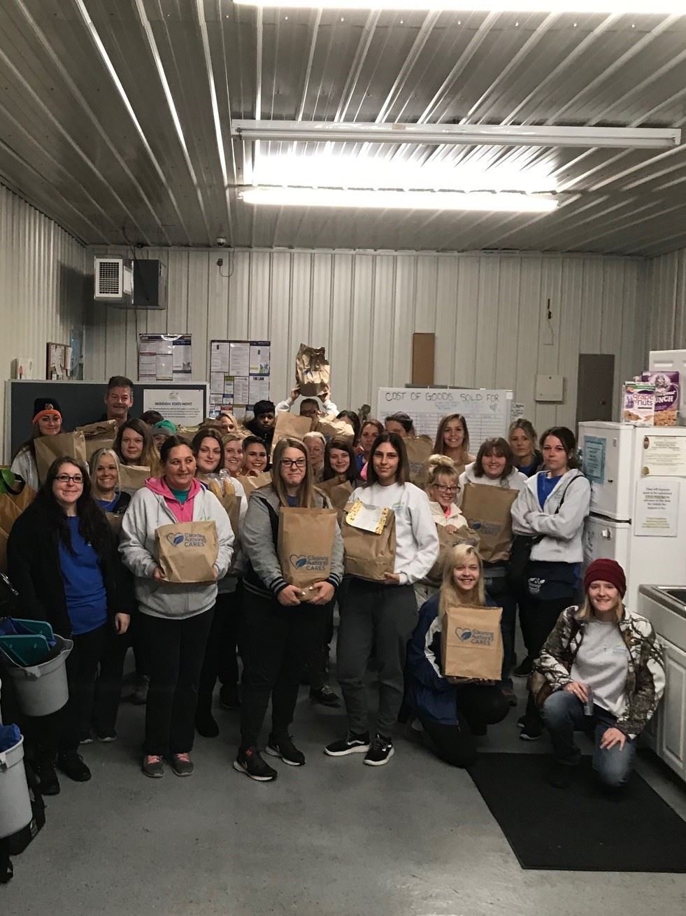 The TCA Cincinnati team poses with the food donations collected for local charities.